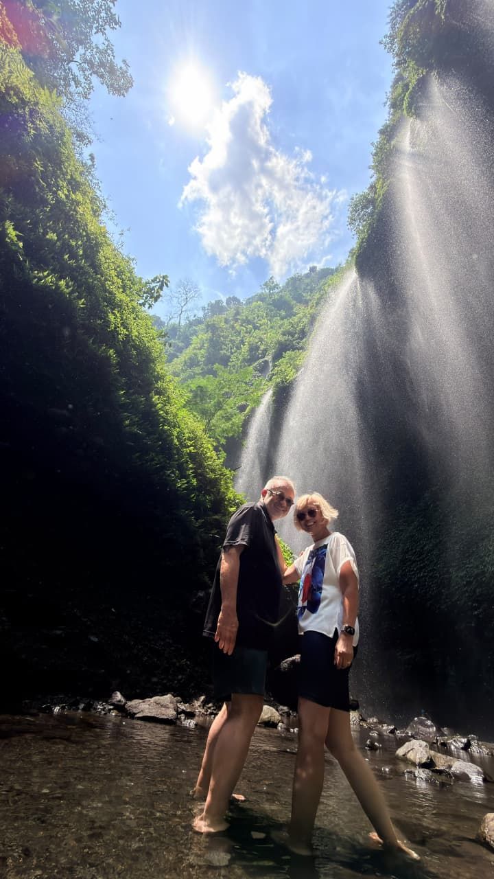 Two guests standing in a waterfall canyon